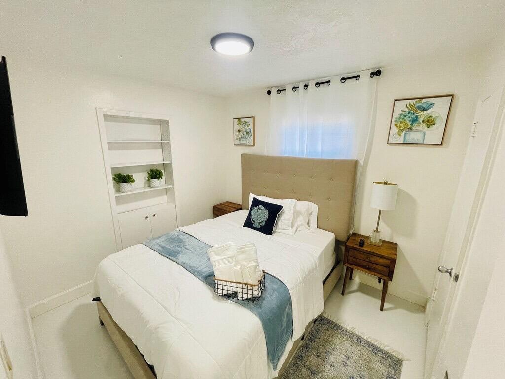 5537 Southwest 6th Street Margate, FL 33068 - Photo 25 of 40 a bedroom with a bed and a window