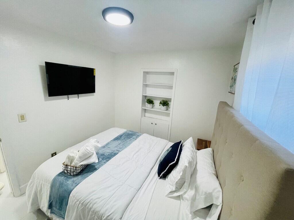 5537 Southwest 6th Street Margate, FL 33068 - Photo 26 of 40 a bedroom with a bed and a flat screen tv