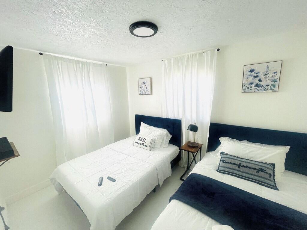 5537 Southwest 6th Street Margate, FL 33068 - Photo 30 of 40 a bedroom with a bed and a night stand
