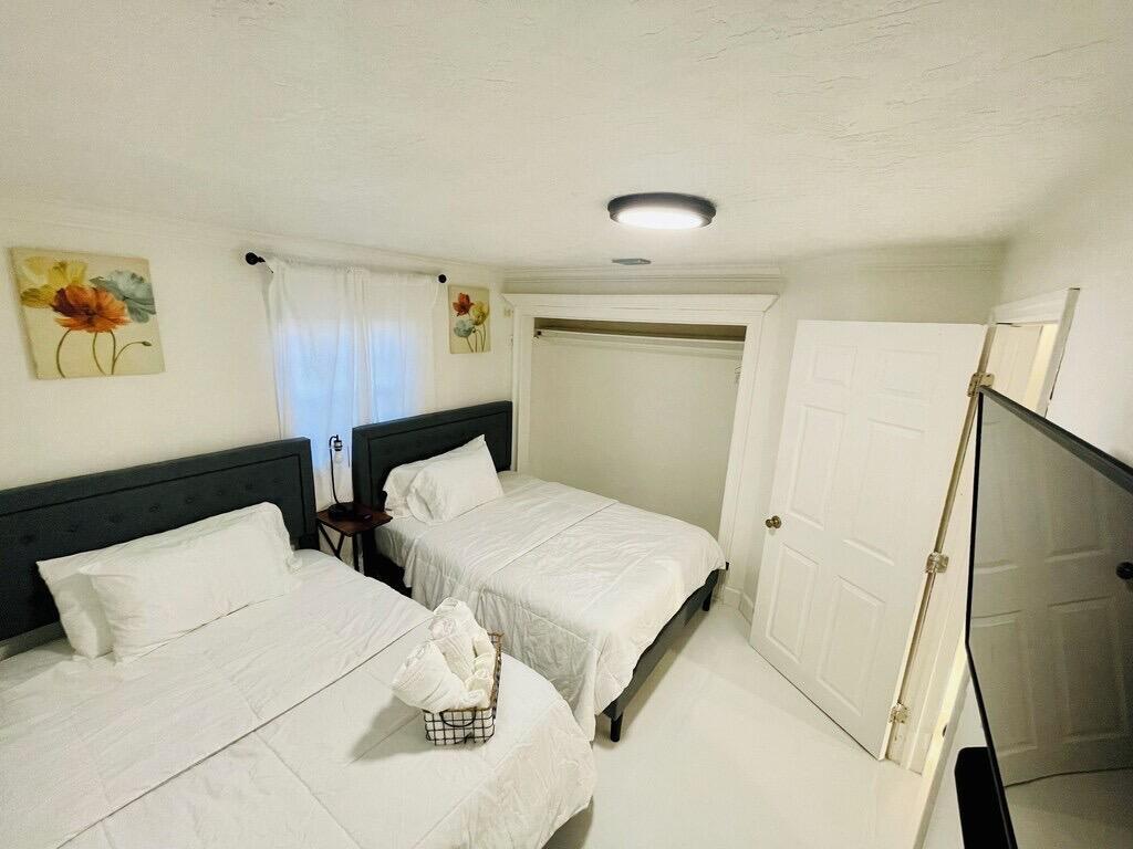 5537 Southwest 6th Street Margate, FL 33068 - Photo 32 of 40 a bedroom with two beds and a large mirror