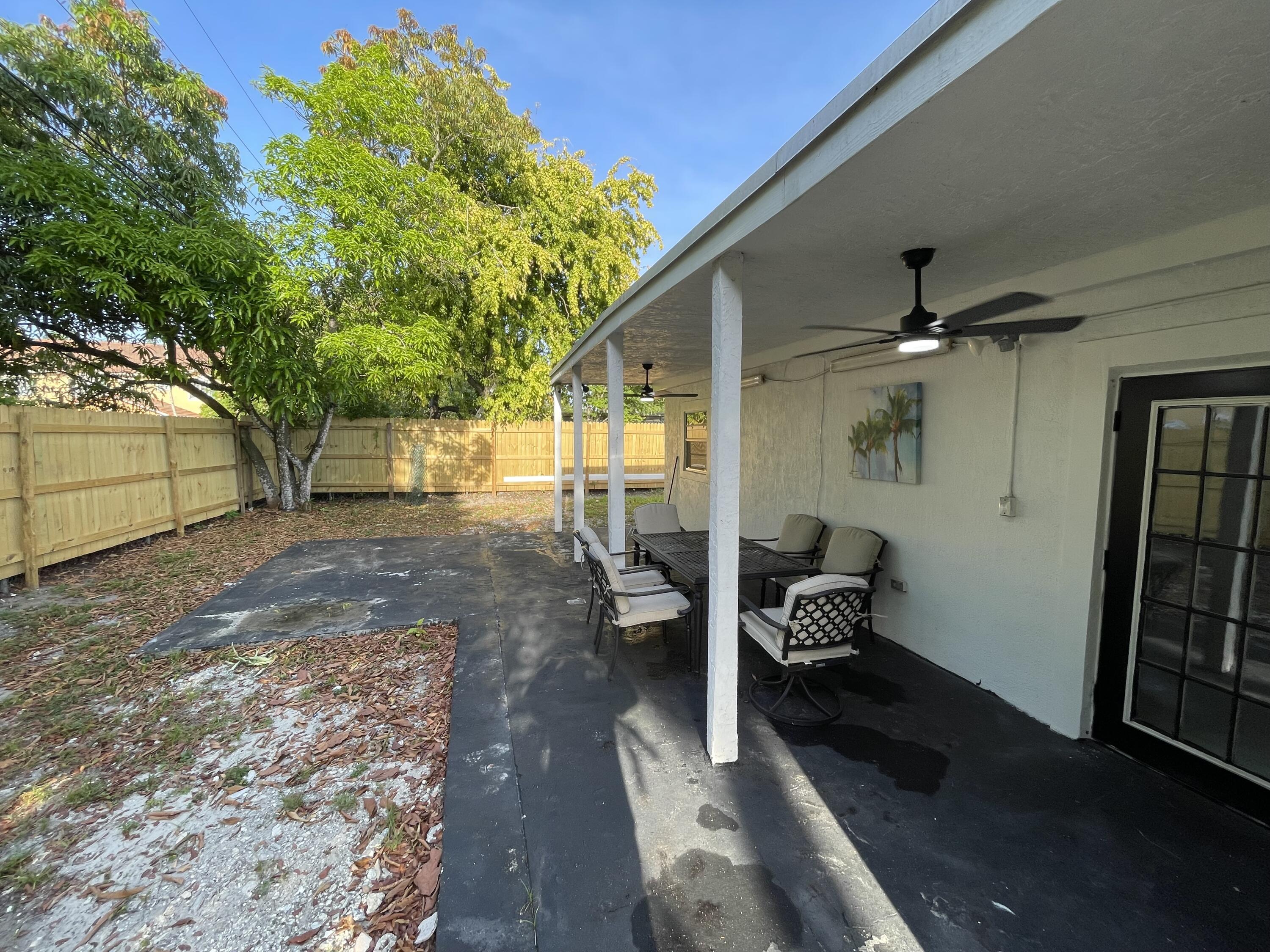 5537 Southwest 6th Street Margate, FL 33068 - Photo 38 of 40 a backyard of a house with table and chairs