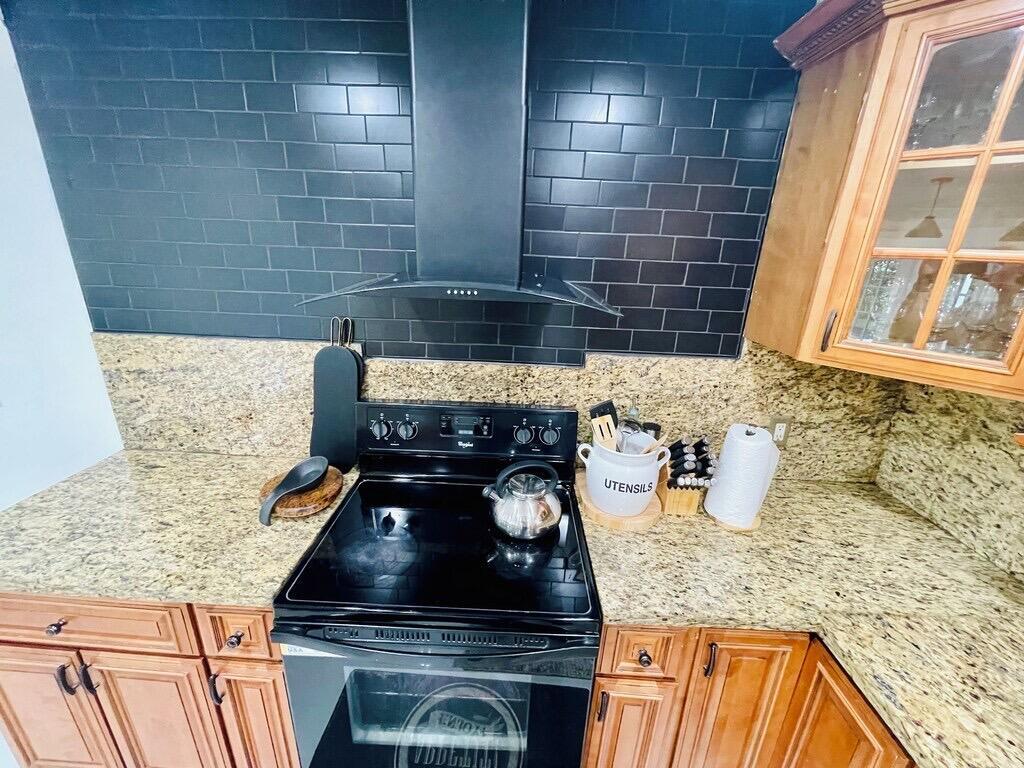 5537 Southwest 6th Street Margate, FL 33068 - Photo 6 of 40 a kitchen with granite countertop white cabinets and a stove