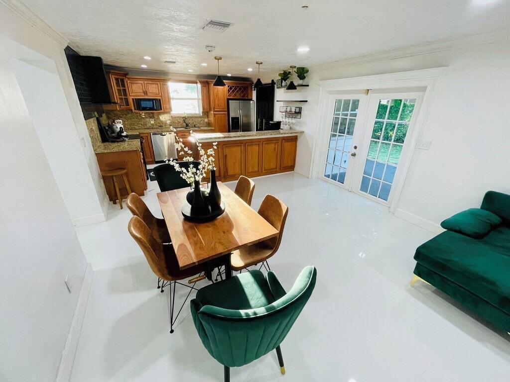 5537 Southwest 6th Street Margate, FL 33068 - Photo 8 of 40 a view of a dining room with furniture and a potted plant