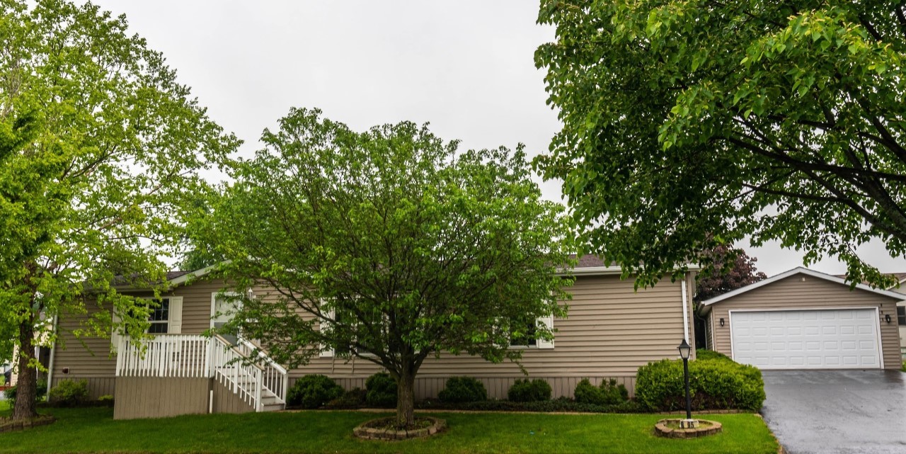a front view of a house with a garden