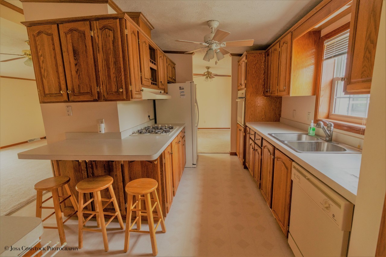 895 Cayuga Trail Marengo, IL 60152 - Photo 13 of 39 a kitchen with stainless steel appliances granite countertop a sink refrigerator and cabinets