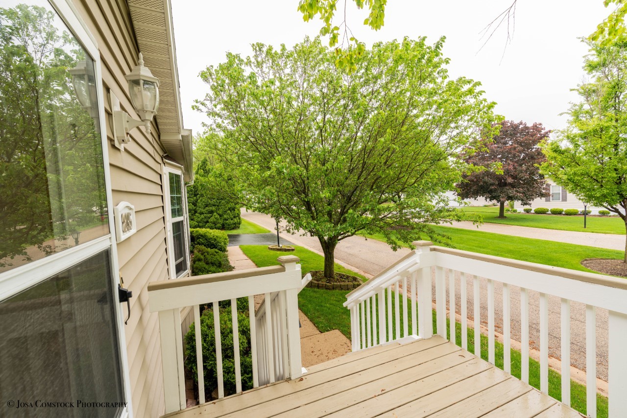 895 Cayuga Trail Marengo, IL 60152 - Photo 3 of 39 a view of a wooden deck and a yard with wooden fence