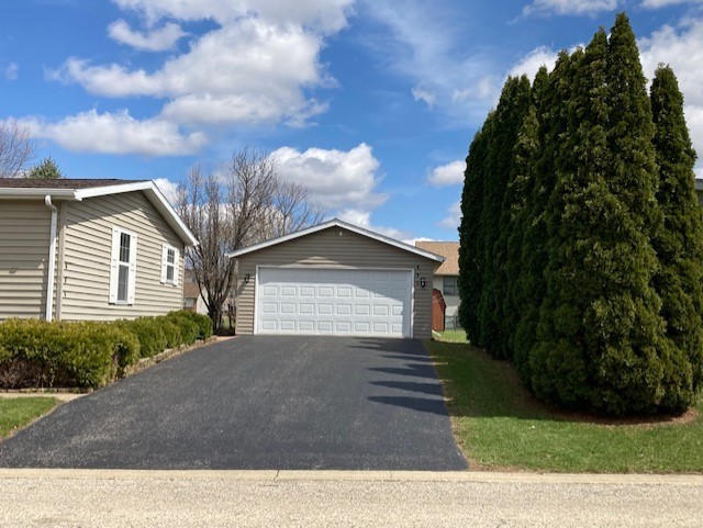 895 Cayuga Trail Marengo, IL 60152 - Photo 38 of 39 a view of a house with a yard and garage
