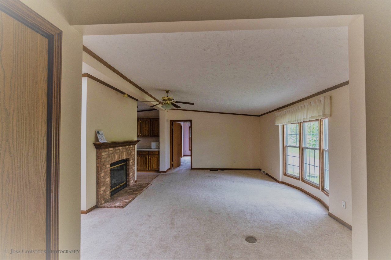 895 Cayuga Trail Marengo, IL 60152 - Photo 8 of 39 an empty room with furniture and a fireplace