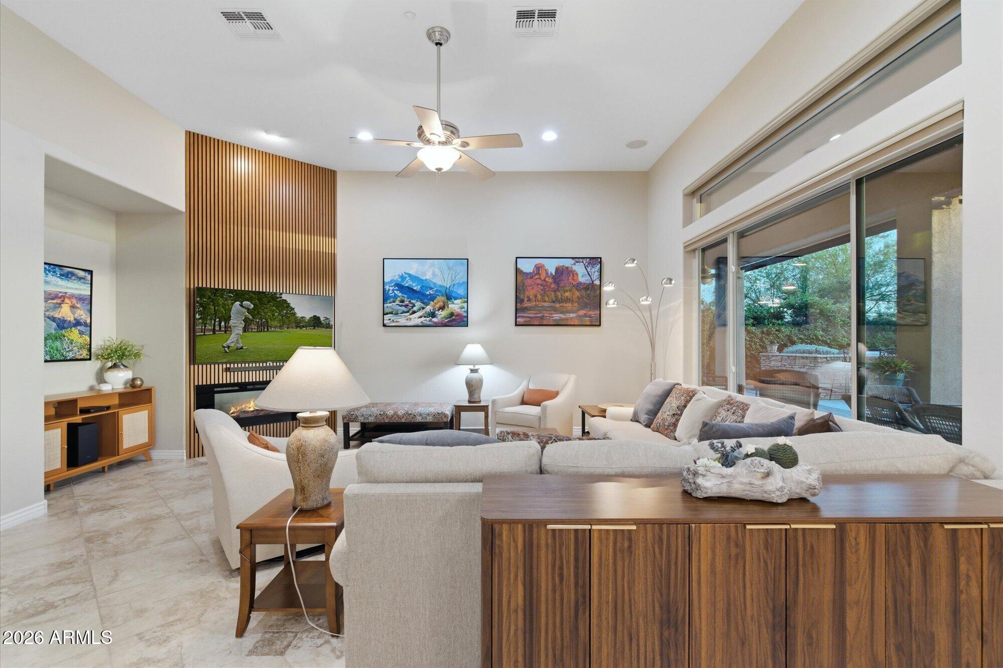 40322 North Hawk Ridge Trail Anthem, AZ 85086 - Photo 13 of 63 a living room with furniture a chandelier and a flat screen tv