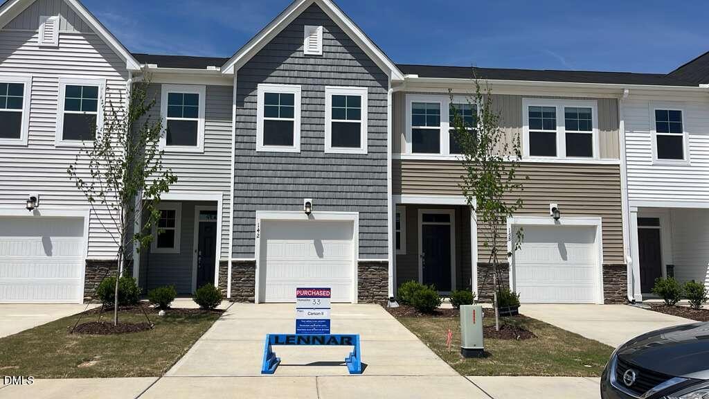 142 Blossom Fld Way Angier, NC 27501 - Photo 1 of 33 a front view of house with yard