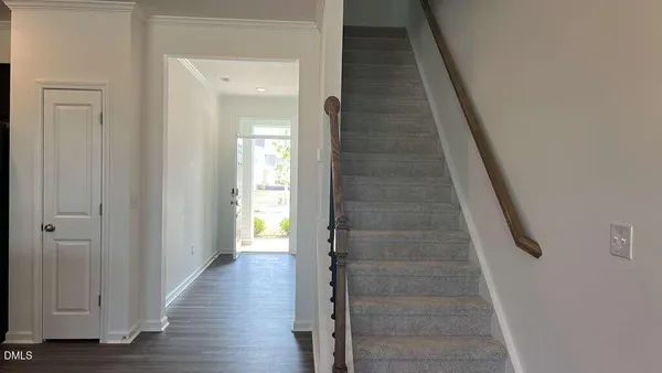 a view of a hallway with wooden floor and entryway