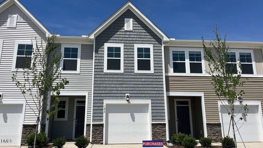 142 Blossom Fld Way Angier, NC 27501 - Photo 2 of 33 a front view of a house with a yard