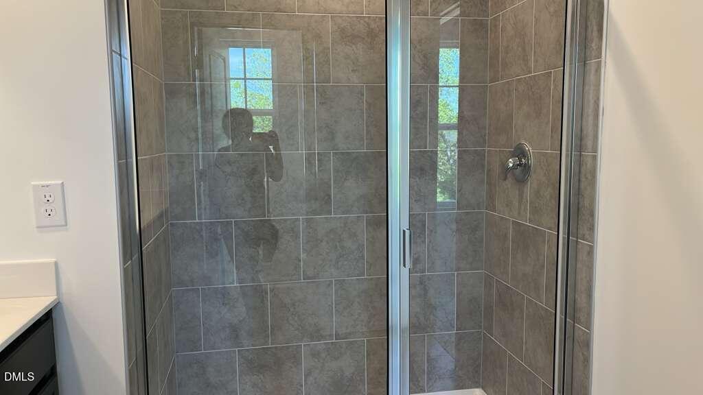 142 Blossom Fld Way Angier, NC 27501 - Photo 27 of 33 a bathroom with a glass shower door