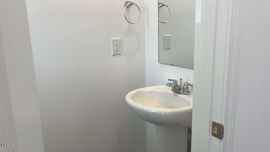 142 Blossom Fld Way Angier, NC 27501 - Photo 5 of 33 a bathroom with a sink and mirror
