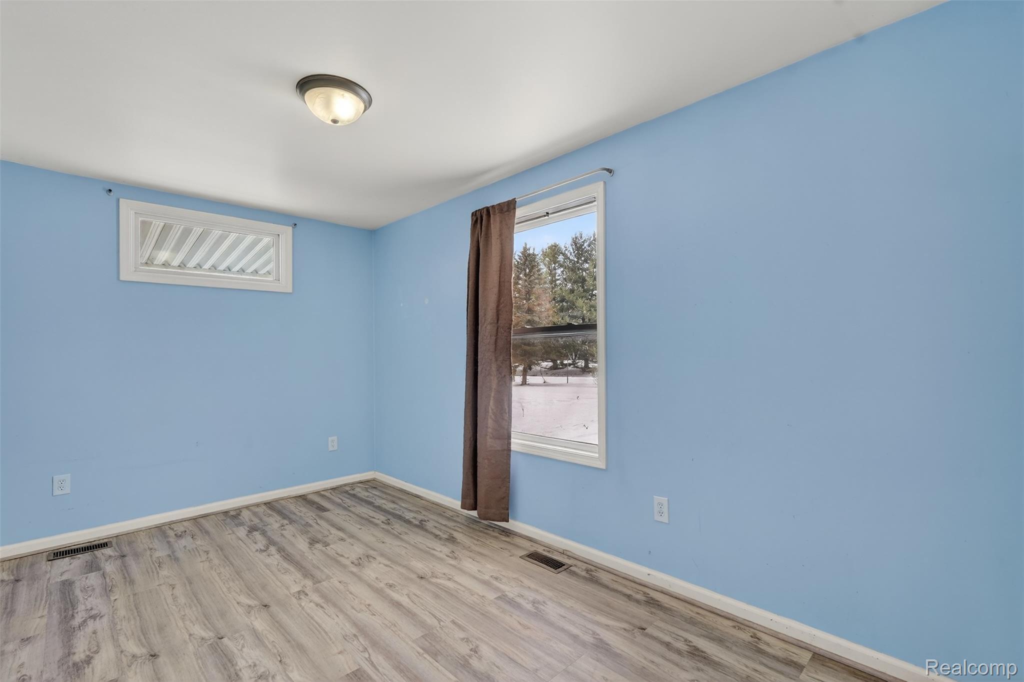 5417 Rensselear Drive Lapeer, MI 48446 - Photo 31 of 41 Unfurnished room featuring wood finished floors and baseboards