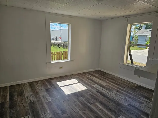 a view of wooden floor and windows in a room