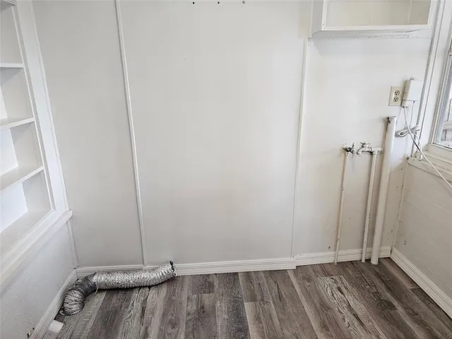 a view of a room with wooden floor