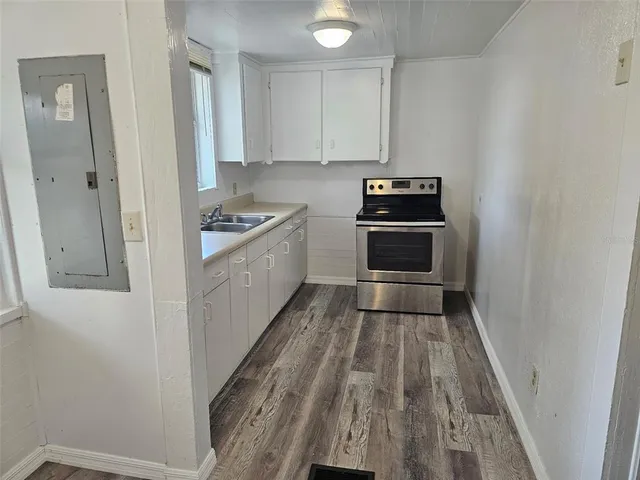 a kitchen with sink and cabinets
