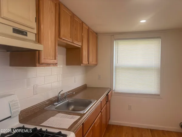 a kitchen with a sink cabinets and a stove top oven