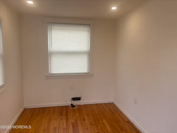 a view of a room with wooden floor and brick walls