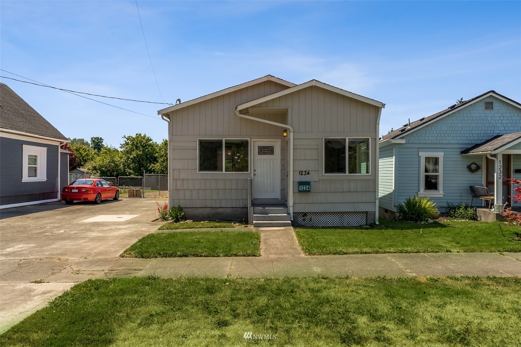 1234 South State Street Tacoma, WA 98405 - Photo 1 of 26 a front view of a house with a yard and garage