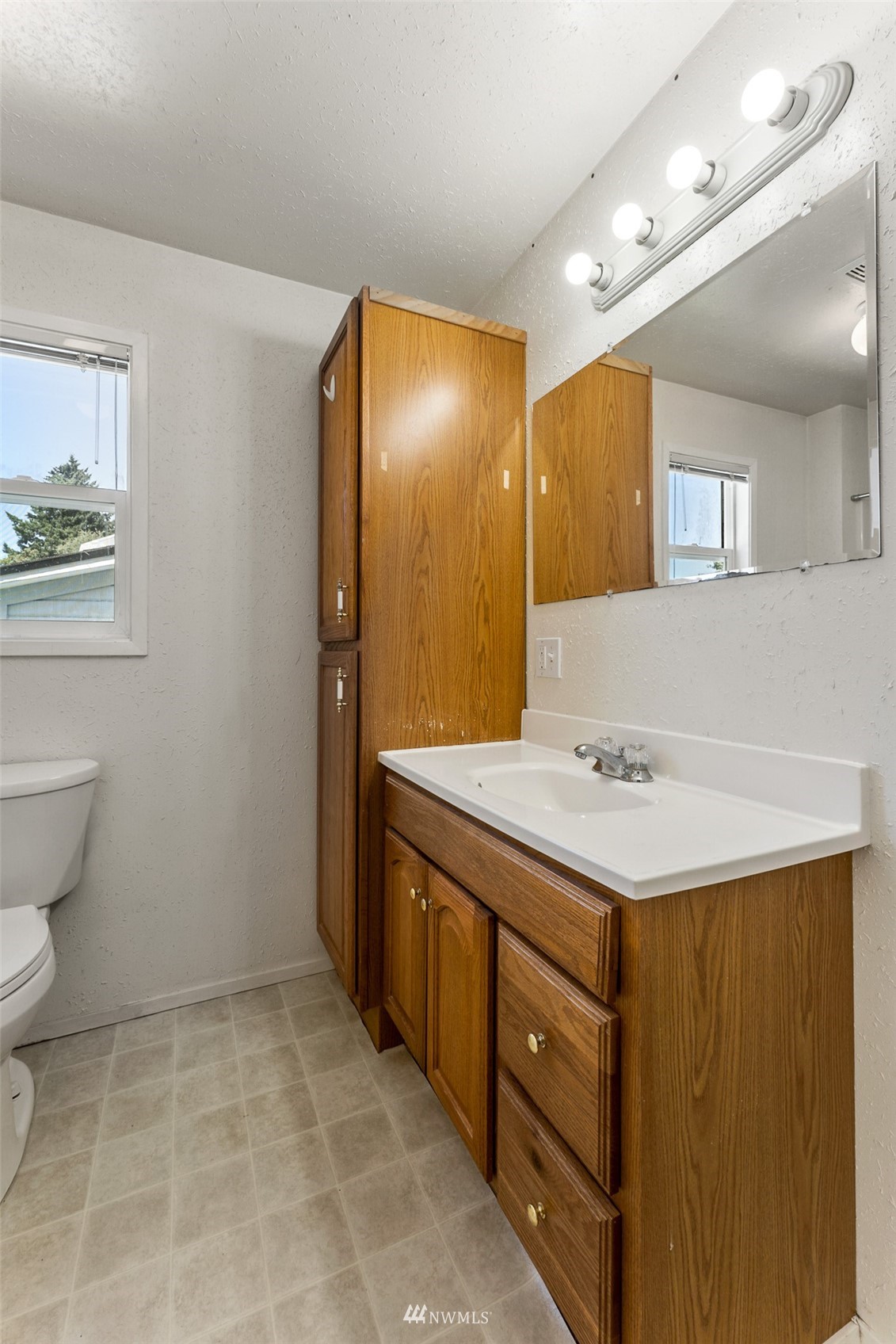 1234 South State Street Tacoma, WA 98405 - Photo 16 of 26 a bathroom with a sink a toilet and mirror