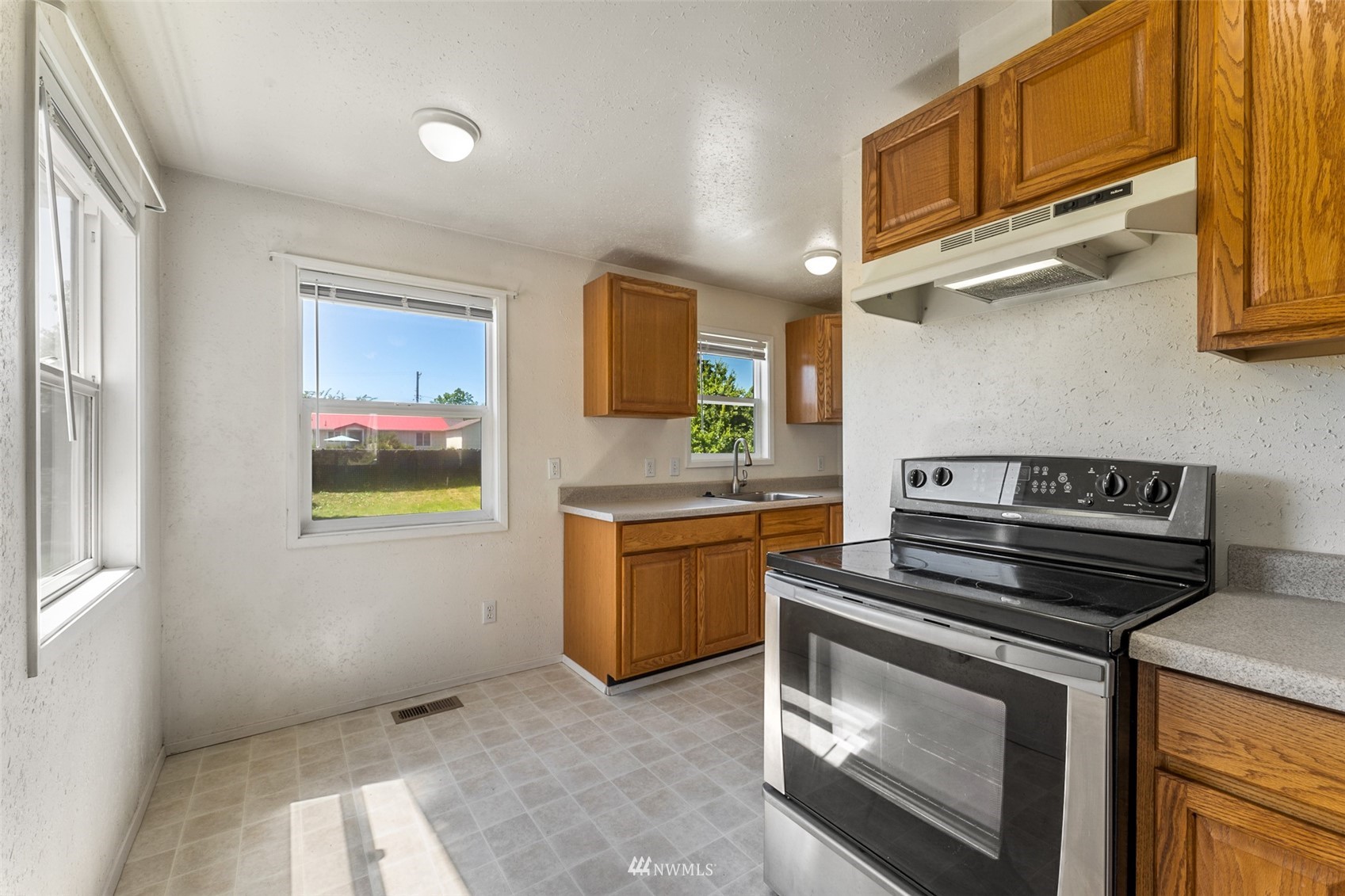 1234 South State Street Tacoma, WA 98405 - Photo 17 of 26 a kitchen with stainless steel appliances granite countertop a stove and a sink