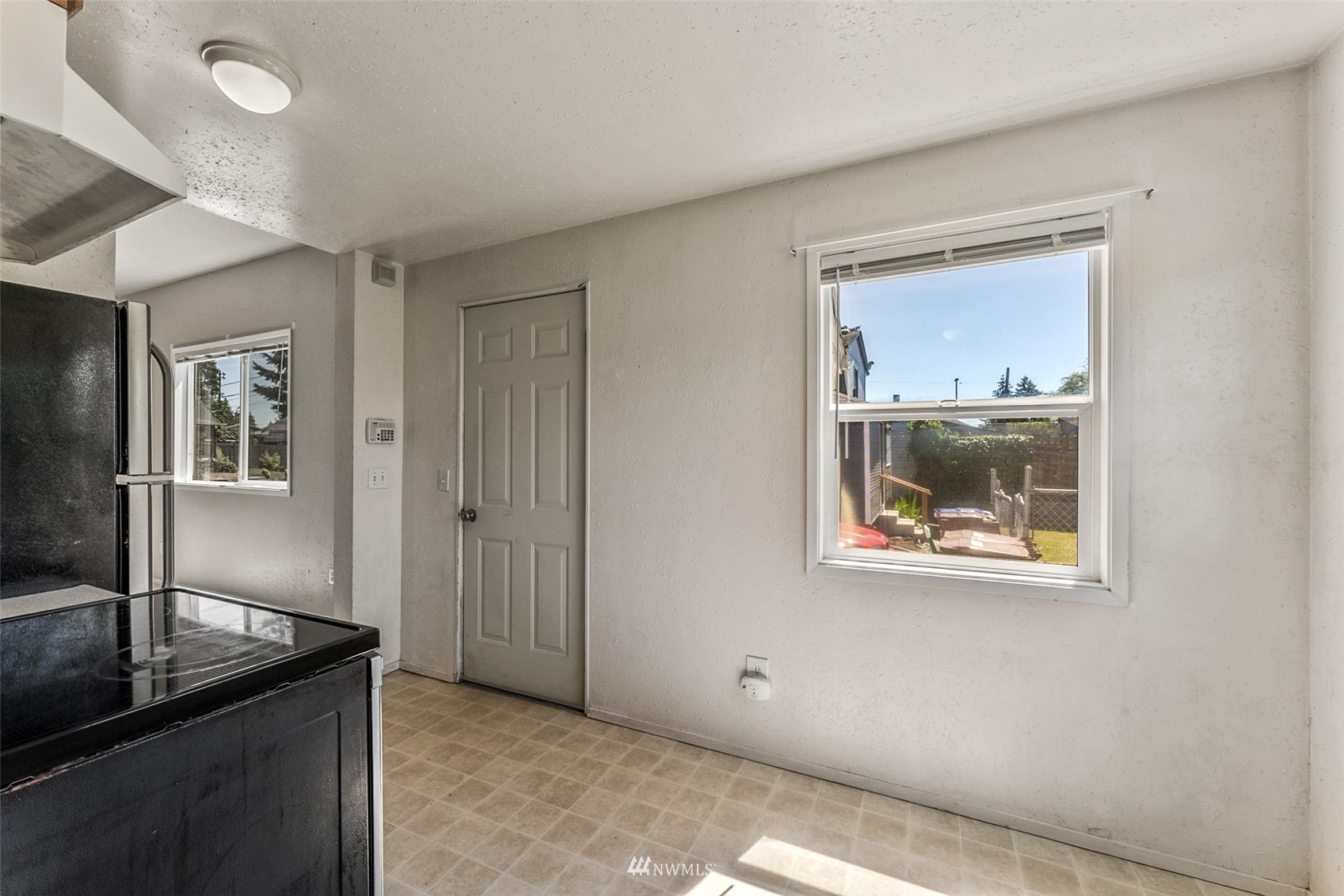 1234 South State Street Tacoma, WA 98405 - Photo 19 of 26 an empty room that has a window and wooden floor