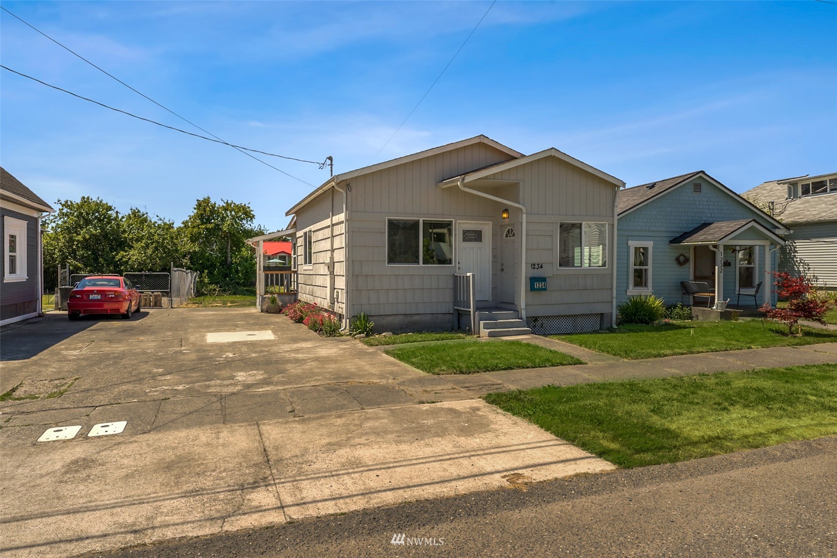 1234 South State Street Tacoma, WA 98405 - Photo 2 of 26 a front view of a house with a yard and garage