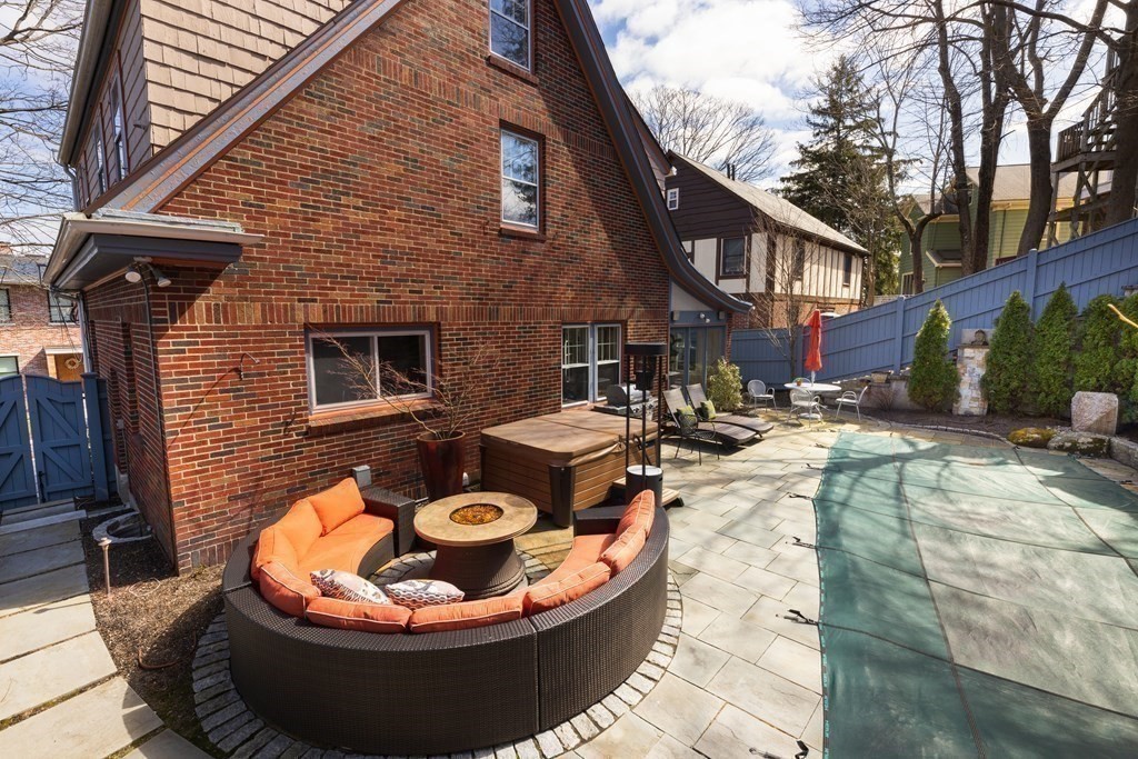 24 Jordan Road Brookline, MA 02446 - Photo 22 of 27 a backyard of a house with fire pit and chairs