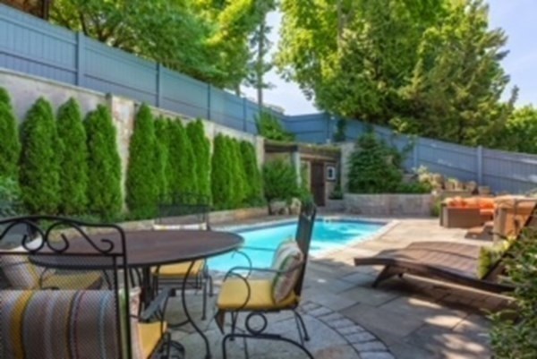 24 Jordan Road Brookline, MA 02446 - Photo 26 of 27 a backyard of a house with table and chairs wooden floor and fence