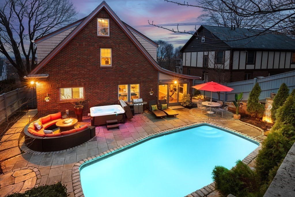 24 Jordan Road Brookline, MA 02446 - Photo 3 of 27 a backyard of a house with fire pit and outdoor seating