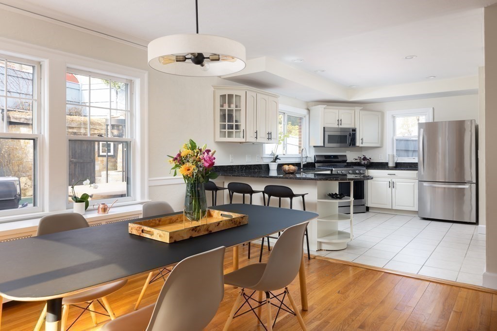 24 Jordan Road Brookline, MA 02446 - Photo 10 of 27 a kitchen with stainless steel appliances granite countertop a stove a refrigerator a kitchen island a dining table and chairs