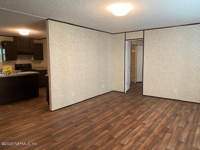 54311 Heron Road Callahan, FL 32011 - Photo 13 of 36 a view of a refrigerator in kitchen and wooden floor