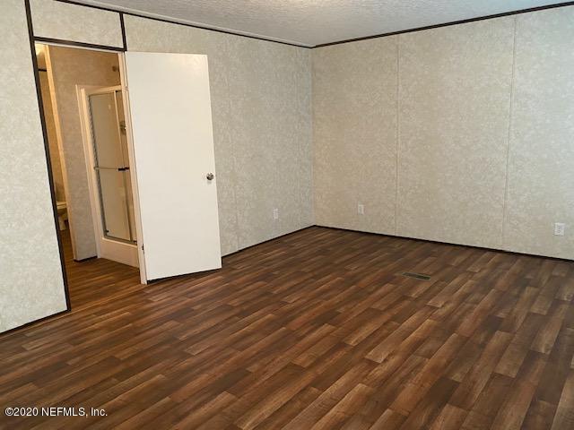 54311 Heron Road Callahan, FL 32011 - Photo 22 of 36 a view of a room with wooden floor and a shower