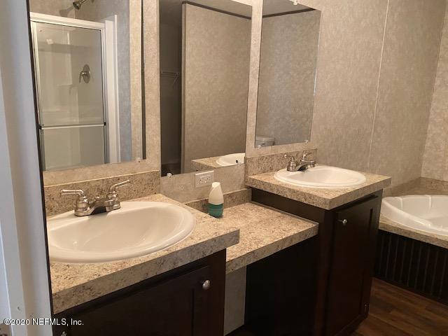 54311 Heron Road Callahan, FL 32011 - Photo 24 of 36 a bathroom with a sink and a mirror