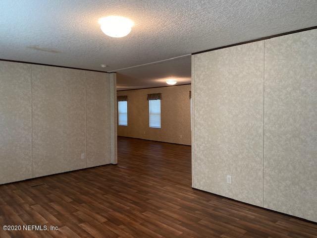 54311 Heron Road Callahan, FL 32011 - Photo 29 of 36 a view of an empty room with wooden floor and a window