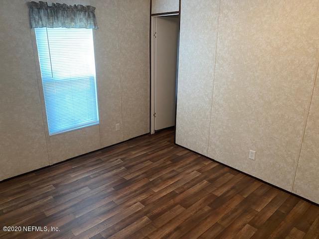 54311 Heron Road Callahan, FL 32011 - Photo 34 of 36 a view of an empty room with wooden floor and a window