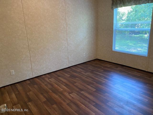 54311 Heron Road Callahan, FL 32011 - Photo 36 of 36 a view of an empty room with wooden floor and a window