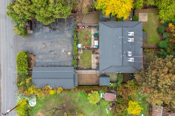 a aerial view of a house with a yard and potted plants