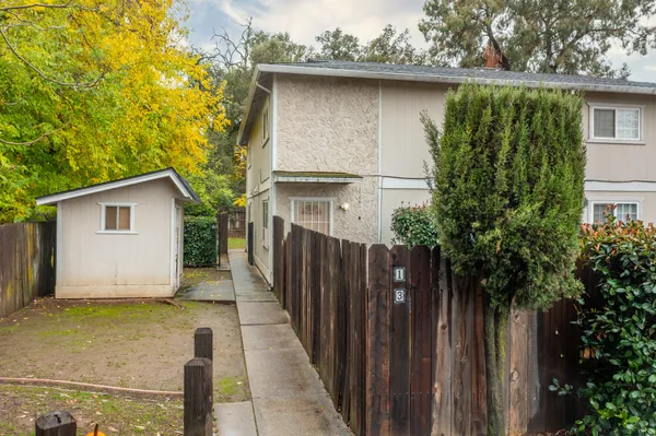 a view of a house with a wooden fence
