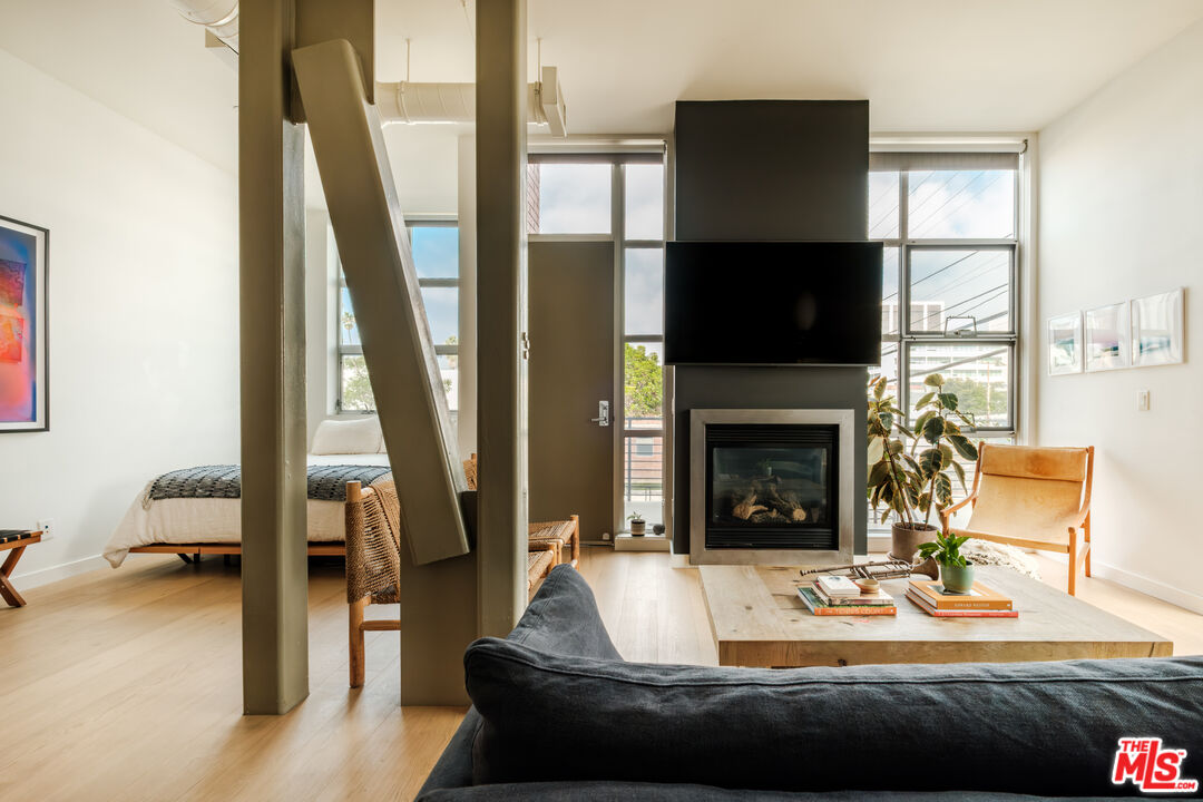 1912 Broadway, Unit 205 Santa Monica, CA 90404 - Photo 3 of 22 a living room with furniture a flat screen tv and a fireplace