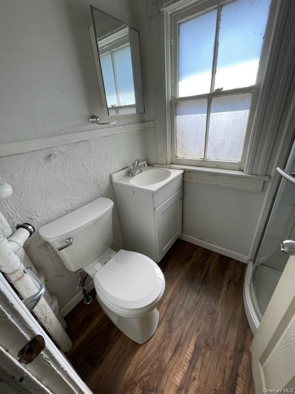 215 North Hamilton Street, Unit 2 Poughkeepsie, NY 12601 - Photo 5 of 5 a white toilet sitting next to a bathroom sink