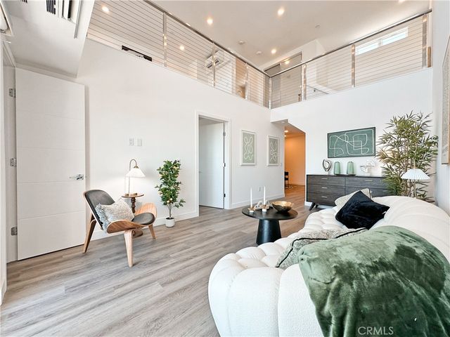 a large bedroom with bed and wooden floor