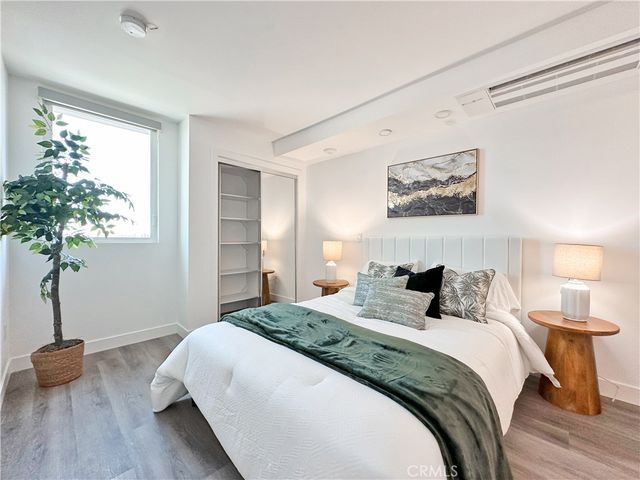 a bedroom with bed and a potted plant