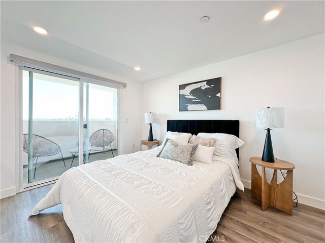 a bedroom with a bed and glass walk in closet