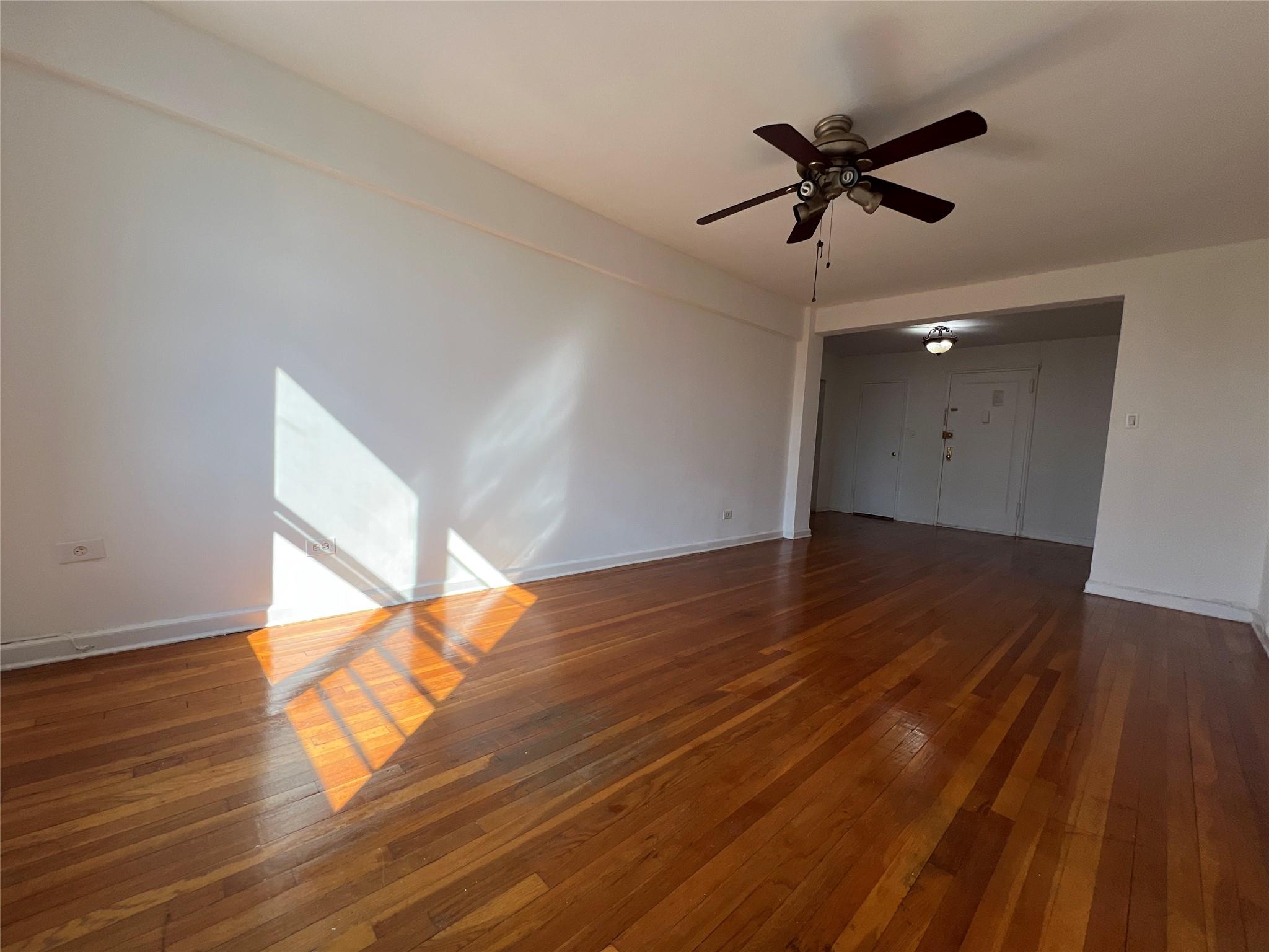1475 Thieriot Avenue, Unit 5J Bronx, NY 10460 - Photo 11 of 14 a view of room and wooden floor