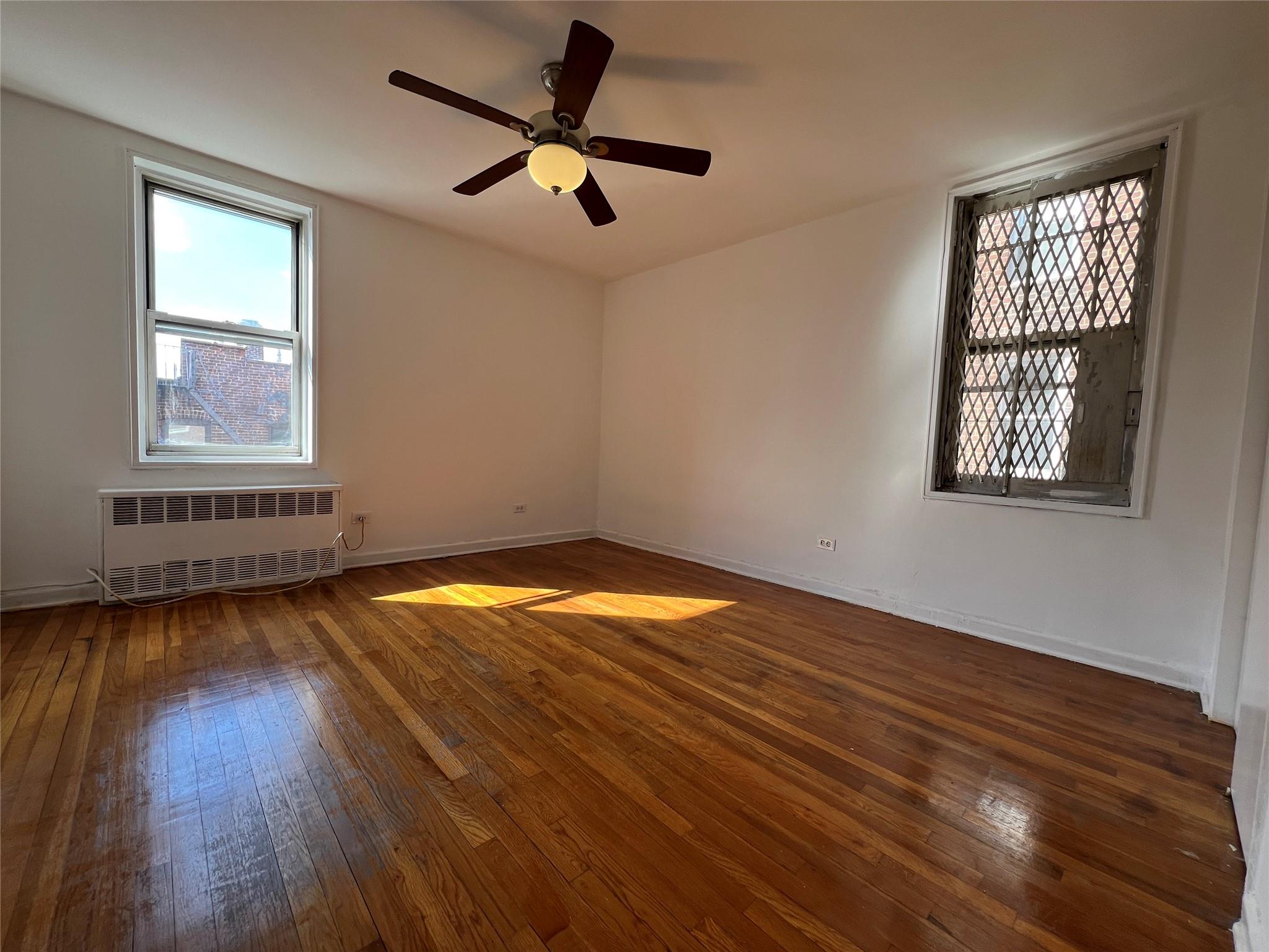 1475 Thieriot Avenue, Unit 5J Bronx, NY 10460 - Photo 13 of 14 wooden floor in an empty room with a window
