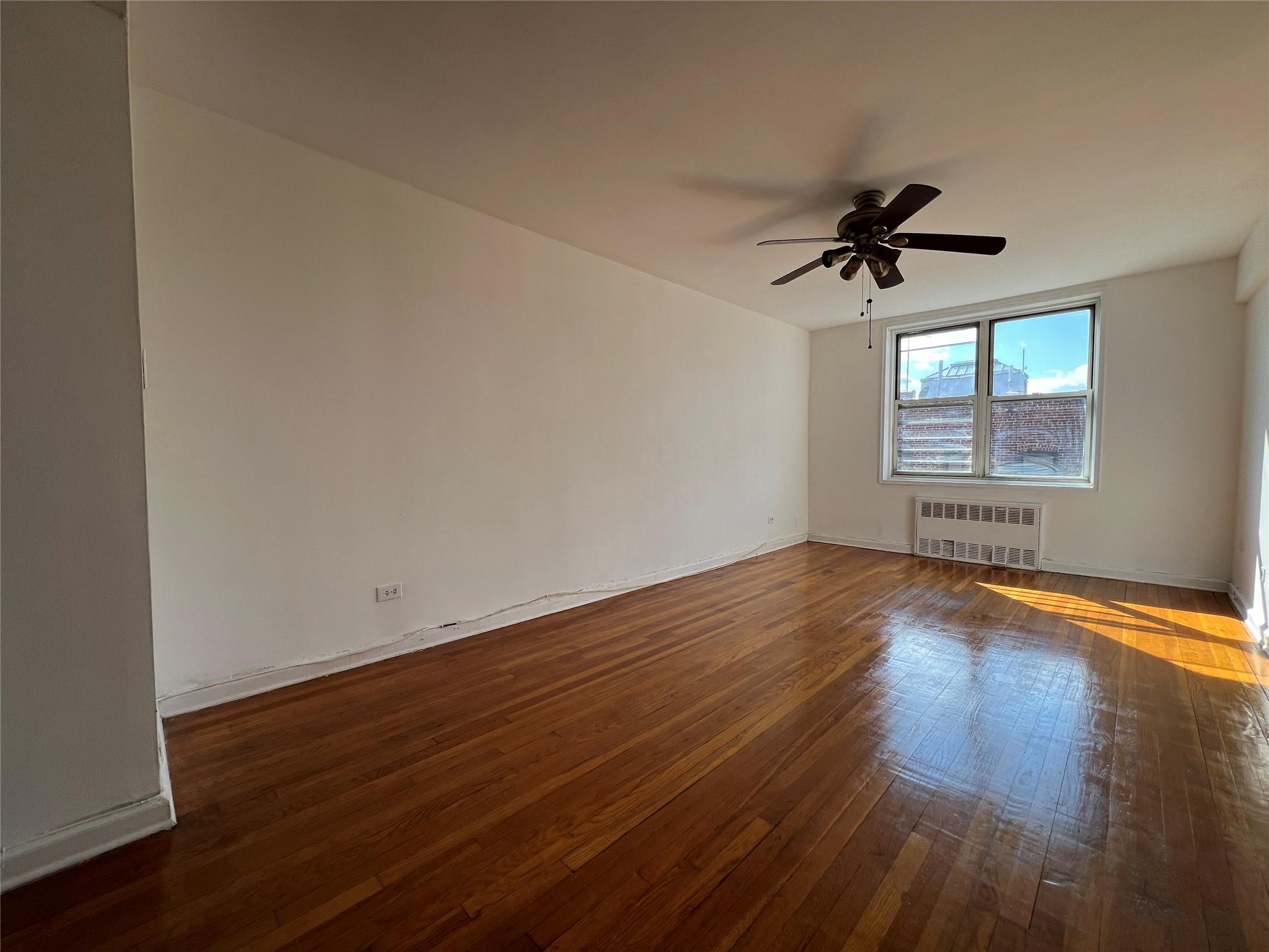 1475 Thieriot Avenue, Unit 5J Bronx, NY 10460 - Photo 14 of 14 a view of empty room with wooden floor and fan