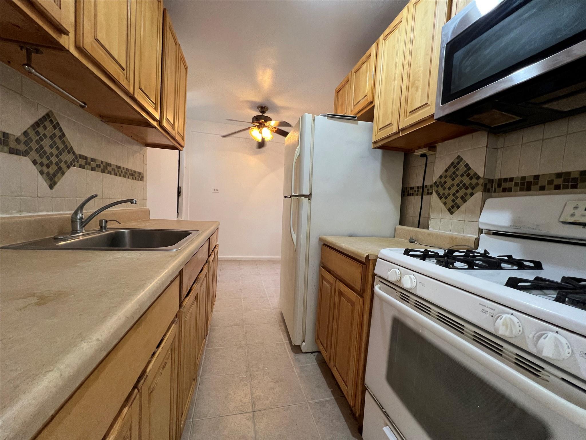 1475 Thieriot Avenue, Unit 5J Bronx, NY 10460 - Photo 6 of 14 a kitchen with a stove and a sink